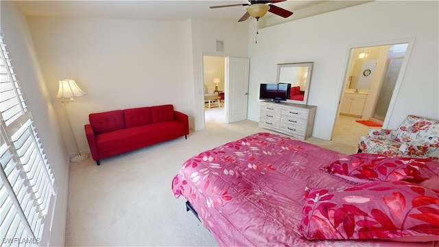 bedroom featuring ensuite bathroom, ceiling fan, and light colored carpet