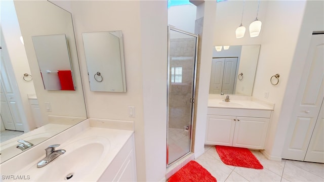 bathroom with tile patterned floors, vanity, and an enclosed shower