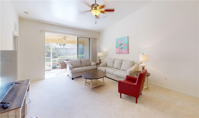 carpeted living room with ceiling fan