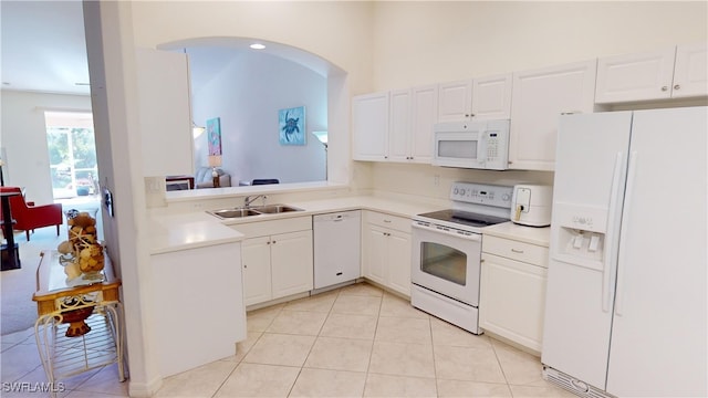 kitchen with white cabinetry, sink, light tile patterned flooring, and white appliances