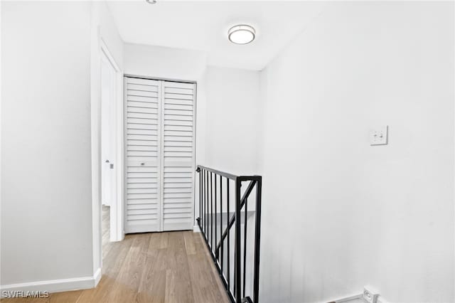 hallway with light hardwood / wood-style flooring