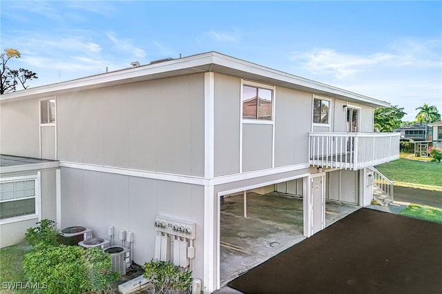 view of side of home with central AC unit