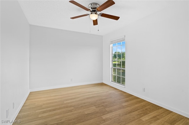 unfurnished room featuring ceiling fan and light wood-type flooring