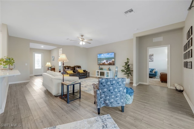 living room featuring ceiling fan and light hardwood / wood-style floors