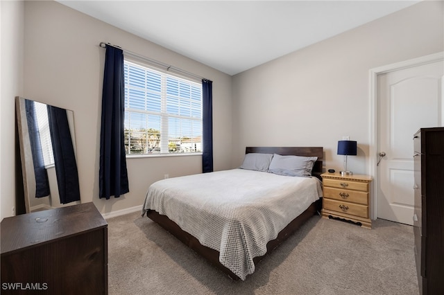 bedroom featuring light colored carpet