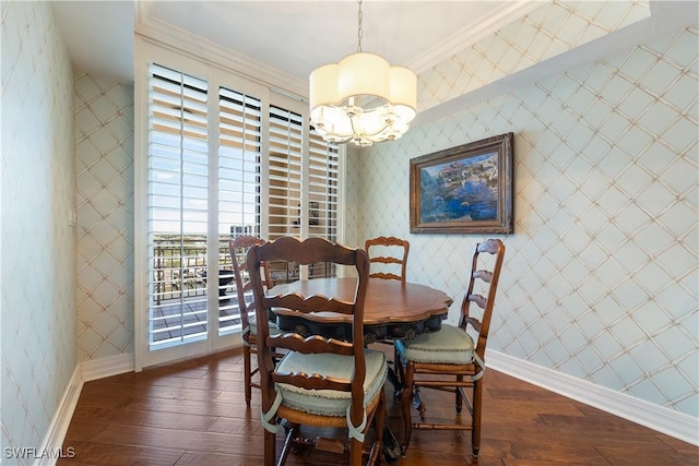 dining room with ornamental molding, a chandelier, and dark hardwood / wood-style floors