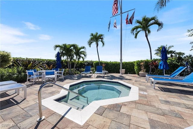 view of pool with a community hot tub and a patio area