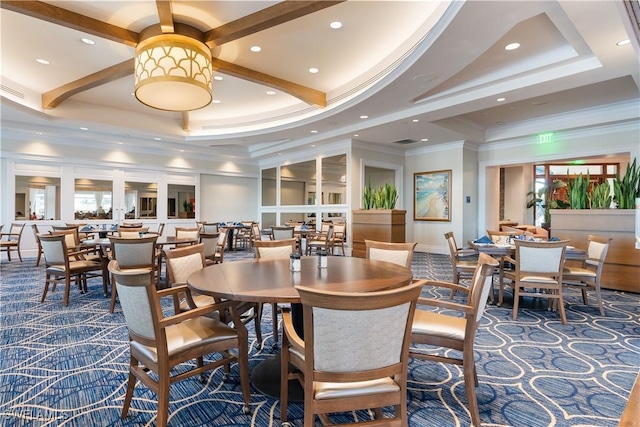 dining space featuring a healthy amount of sunlight, ornamental molding, and dark carpet