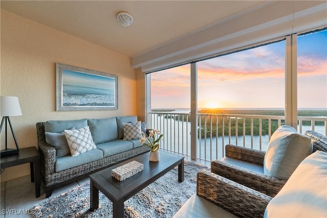 sunroom / solarium with a water view