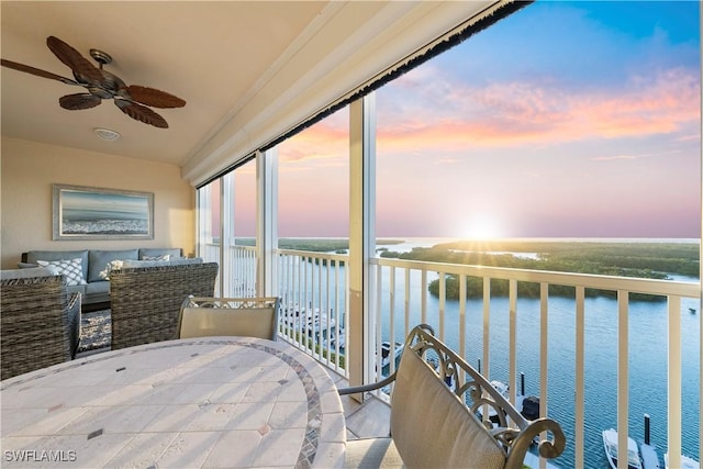 interior space with ceiling fan and a water view