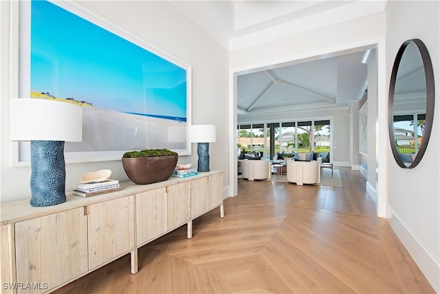 hall featuring vaulted ceiling and light parquet floors