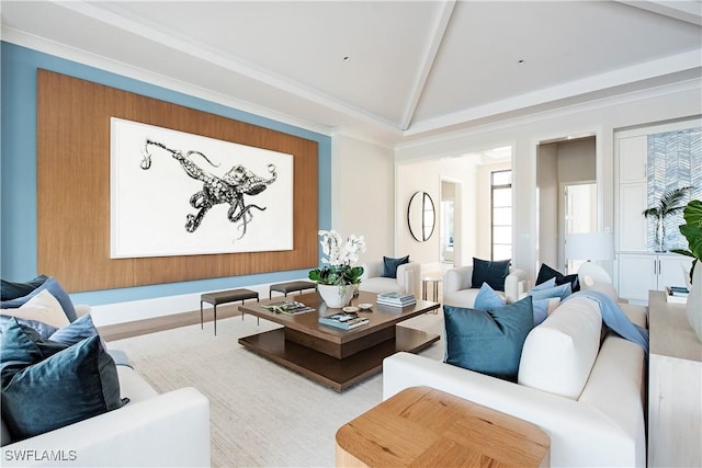 living room featuring ornamental molding, vaulted ceiling, and wood finished floors