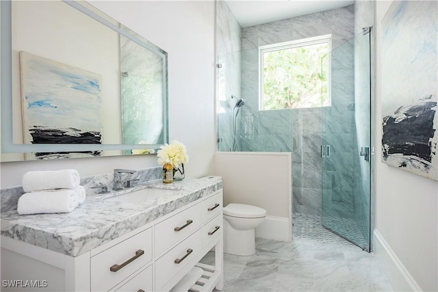 bathroom featuring marble finish floor, toilet, a shower stall, vanity, and baseboards