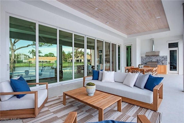 interior space featuring wood ceiling and a raised ceiling