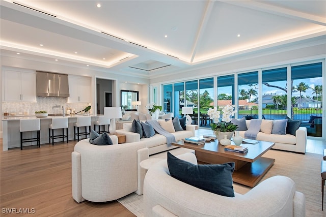 living room with light wood-type flooring and recessed lighting