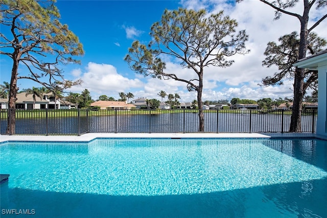 view of swimming pool with a residential view, fence, and a fenced in pool