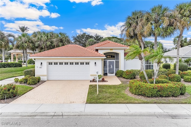 mediterranean / spanish-style house featuring a front lawn and a garage