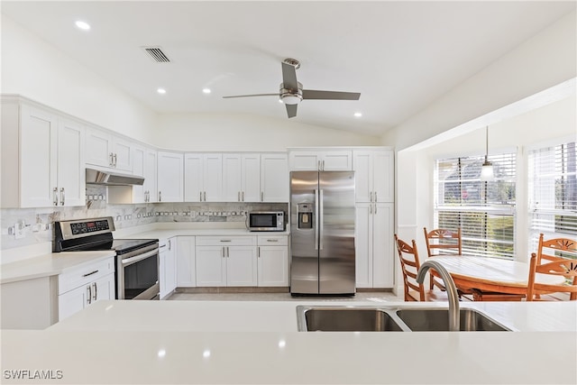 kitchen featuring lofted ceiling, white cabinets, appliances with stainless steel finishes, and sink