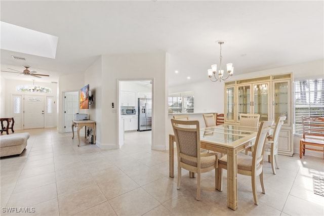 tiled dining room featuring an inviting chandelier