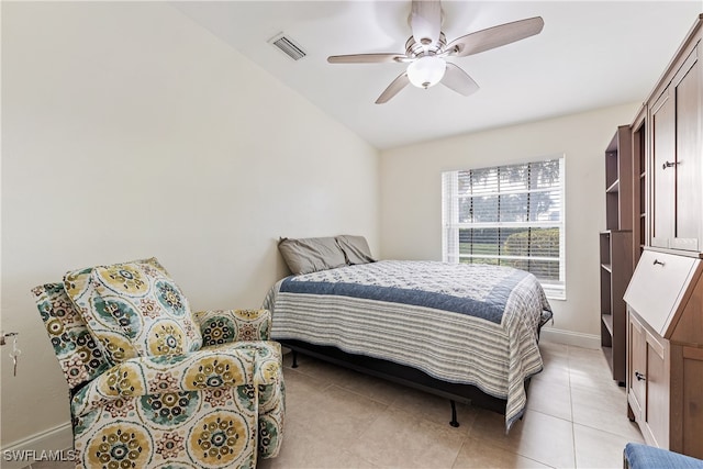 bedroom with ceiling fan, light tile patterned floors, and lofted ceiling