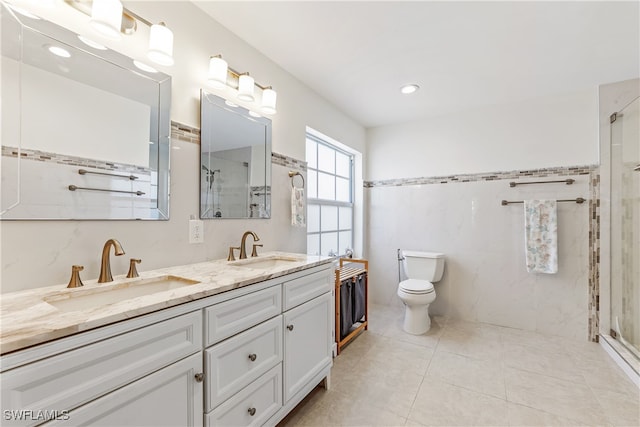 bathroom with a shower with door, toilet, and vanity