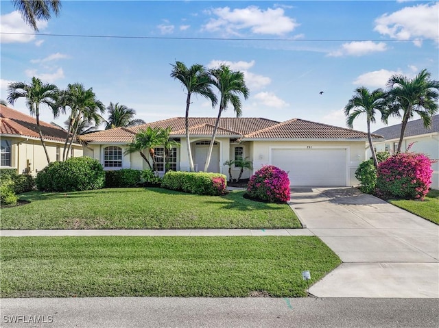 view of front of home featuring a garage and a front yard