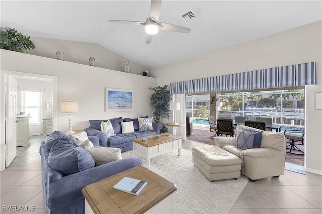 living room featuring ceiling fan, light tile patterned flooring, and lofted ceiling