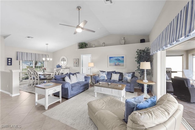 living room with lofted ceiling, light tile patterned floors, and ceiling fan with notable chandelier