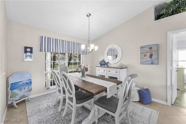 tiled dining space with an inviting chandelier and vaulted ceiling