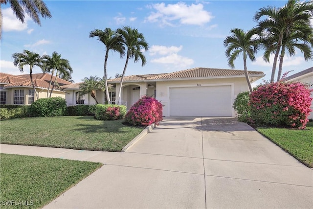 view of front of home with a garage and a front lawn