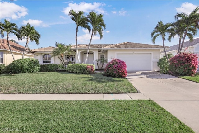 view of front of property featuring a front yard and a garage