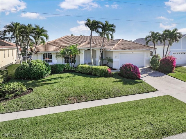 view of front of home with a garage and a front yard