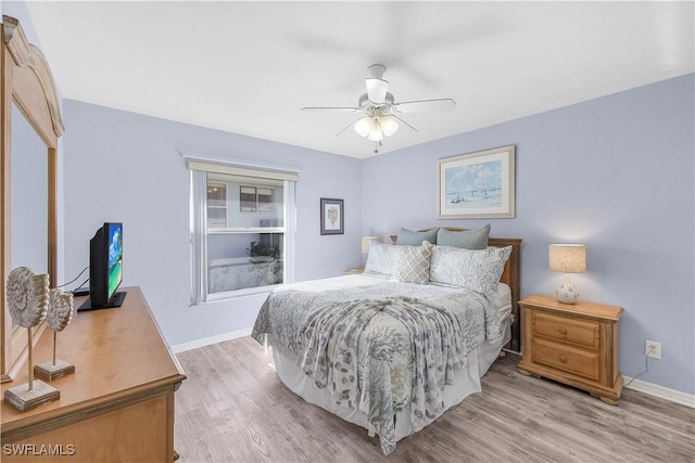 bedroom featuring light hardwood / wood-style floors and ceiling fan