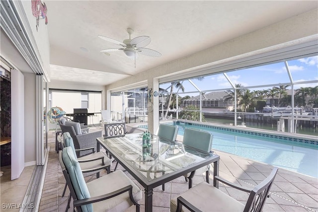 sunroom with a water view, ceiling fan, and lofted ceiling