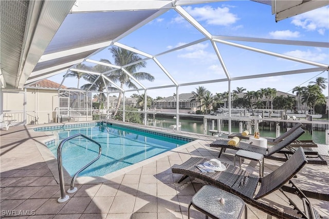 view of swimming pool with a lanai, a patio area, and a water view