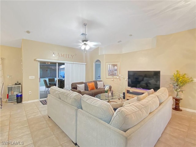 tiled living room featuring ceiling fan