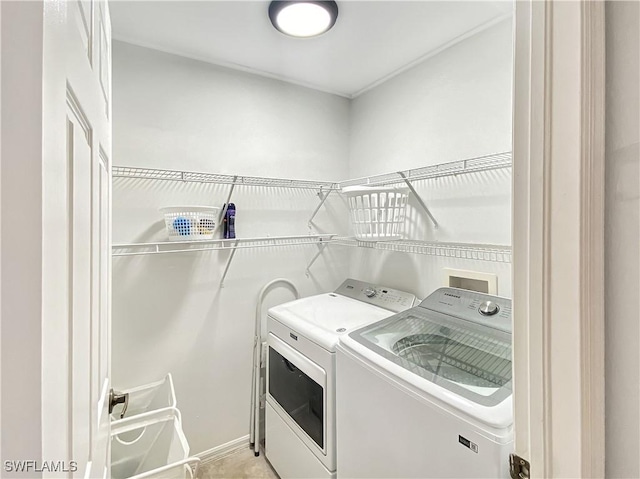 clothes washing area featuring washer and clothes dryer