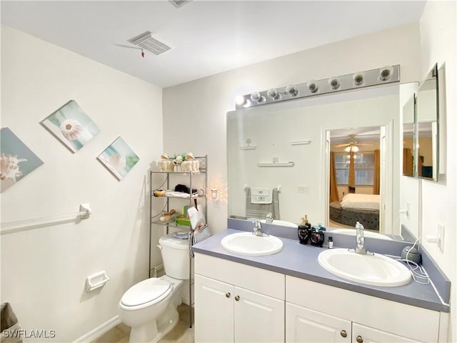 bathroom with vanity, toilet, and ceiling fan