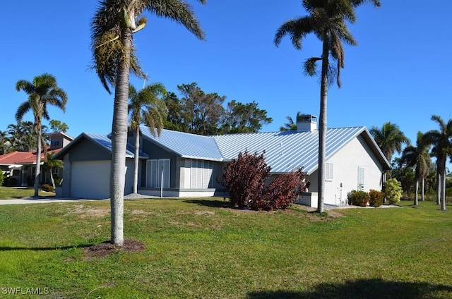 ranch-style house featuring a garage and a front lawn