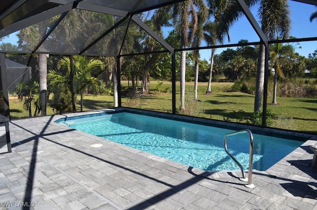 view of swimming pool with a lanai, a patio area, and a lawn