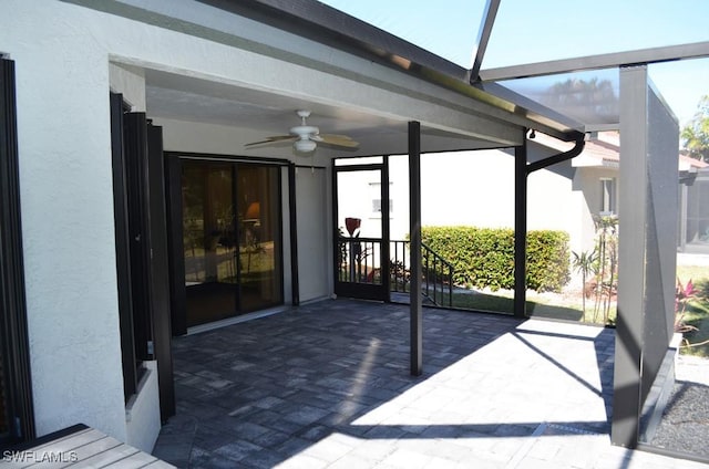 sunroom featuring ceiling fan