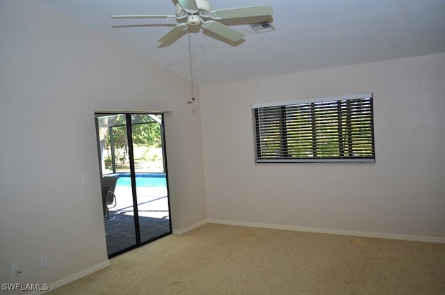 carpeted empty room featuring high vaulted ceiling and ceiling fan