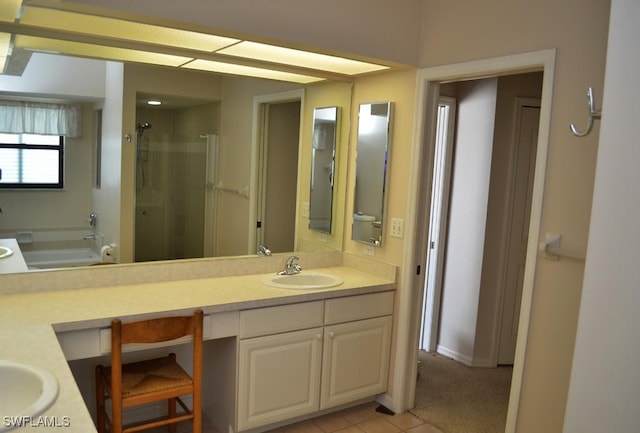 bathroom with a shower with door, tile patterned flooring, and vanity