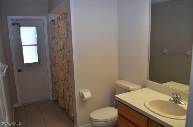 bathroom with tile patterned flooring, vanity, and toilet