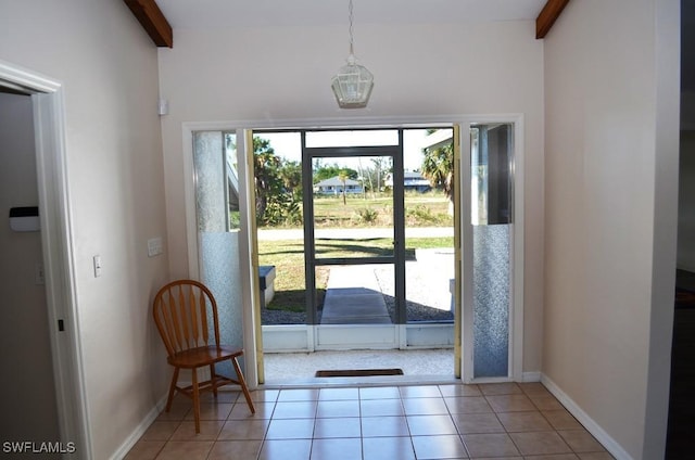 entryway with light tile patterned floors and beam ceiling