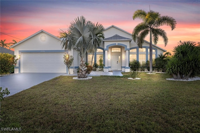 view of front of house with a lawn and a garage