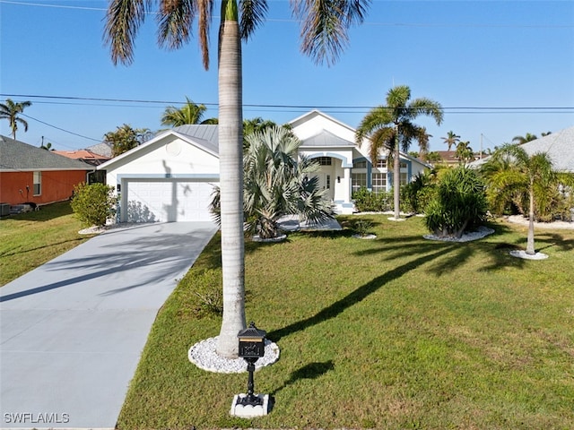 view of front of home with a garage and a front lawn