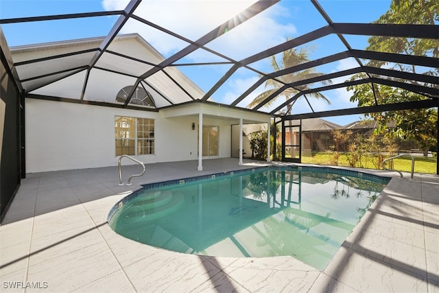 view of swimming pool featuring a patio area and a lanai