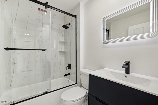 full bathroom with shower / bath combination with glass door, vanity, and toilet