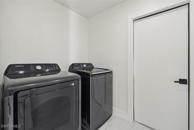 washroom featuring washer and clothes dryer